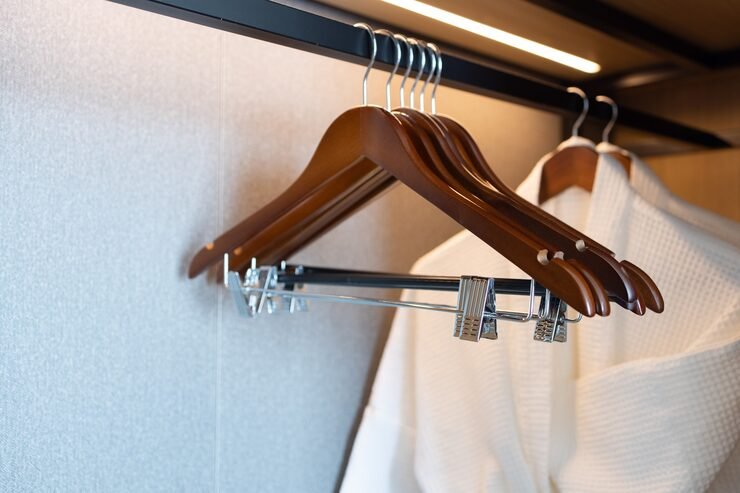 Wooden hangers in wardrobe