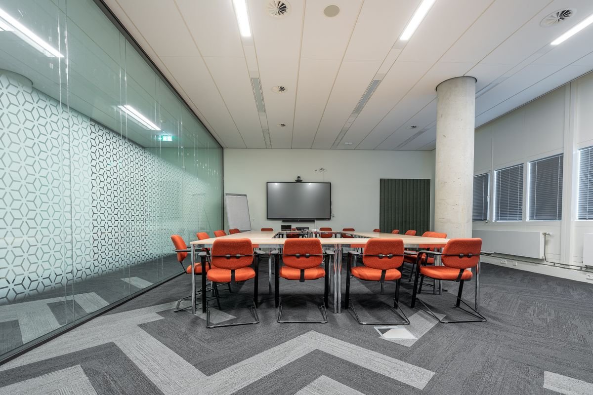Modern meeting room with video conferencing screen